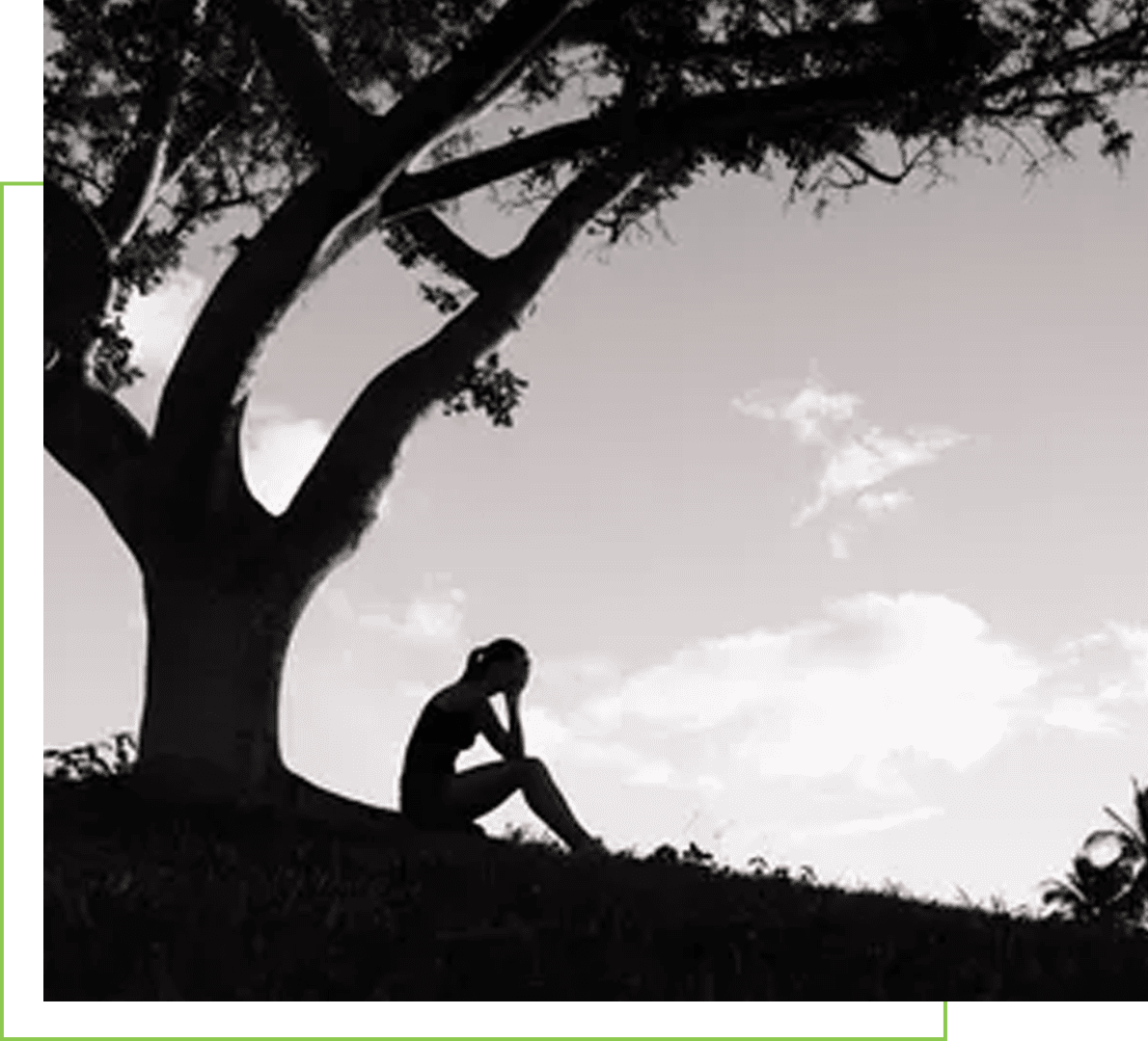 re-img A person sitting on the ground under a tree.